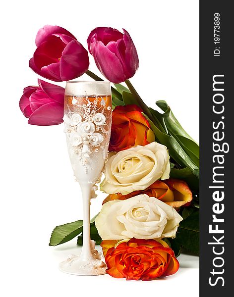One glass of wine with roses and tulips. Isolated on white. One glass of wine with roses and tulips. Isolated on white