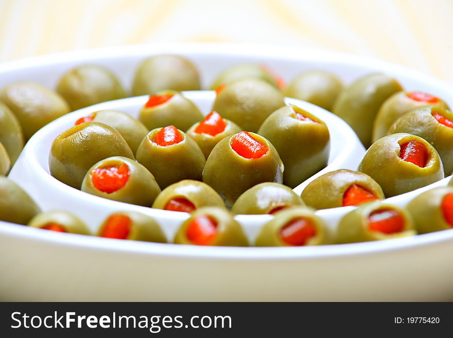 Stuffed green olives on ceramic plate