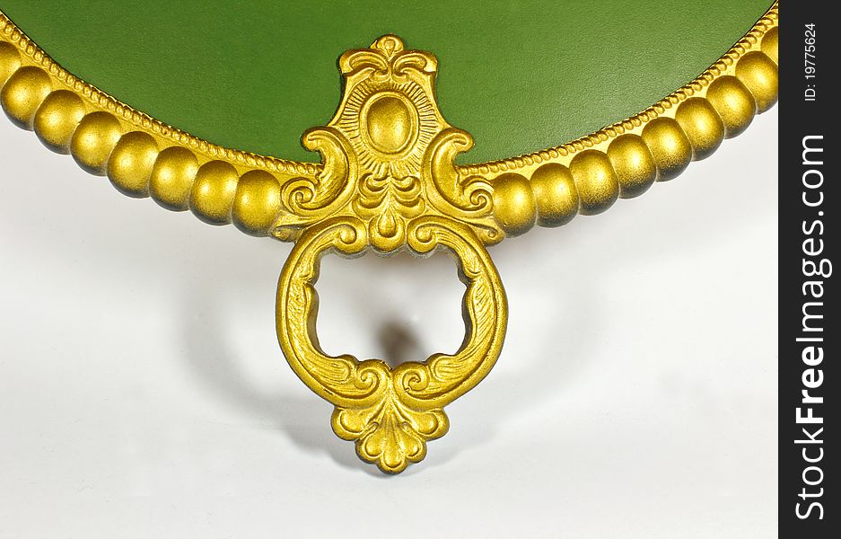 Element of the wall of the mechanical clock of green and gold on a white background. Element of the wall of the mechanical clock of green and gold on a white background