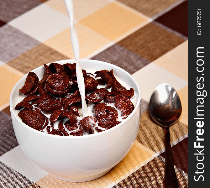 Pouring milk into ceramic bowl full of cereals. Pouring milk into ceramic bowl full of cereals