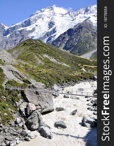 Walking across a bridge to Mount Cook. Walking across a bridge to Mount Cook