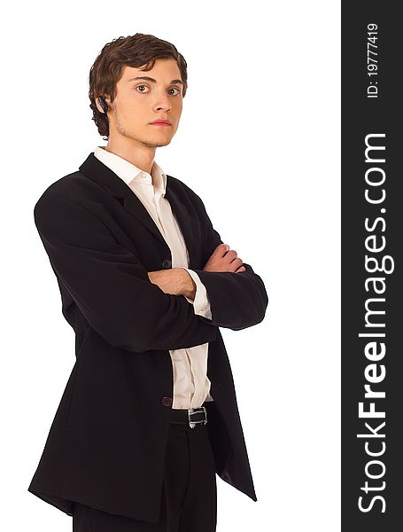 Confident young business man standing and looking seriously