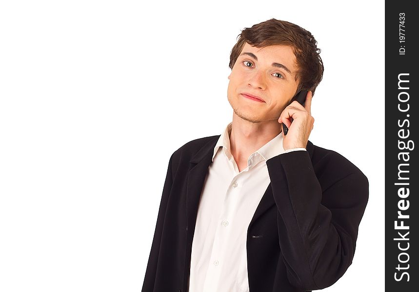 Relaxed young business man making a call standing and looking at camera