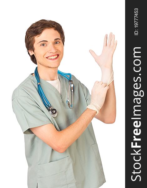 Happy young medical worker standing putting on gloves on white background. Happy young medical worker standing putting on gloves on white background