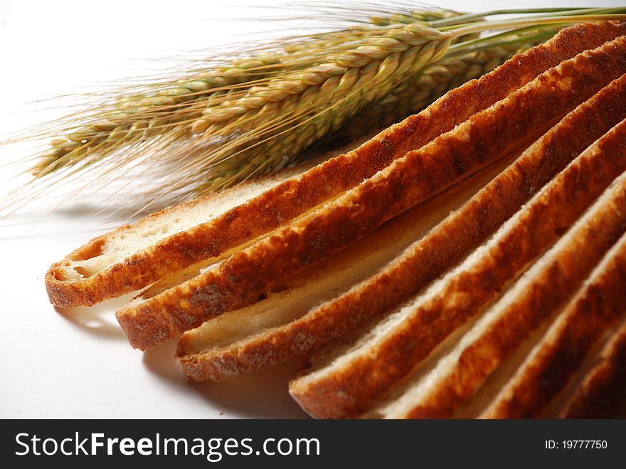 Slices of bread and ears on white background. Slices of bread and ears on white background