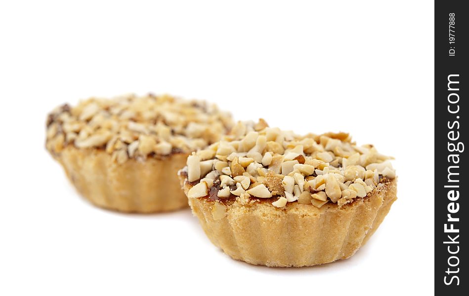 Cake topped with peanuts on a white background