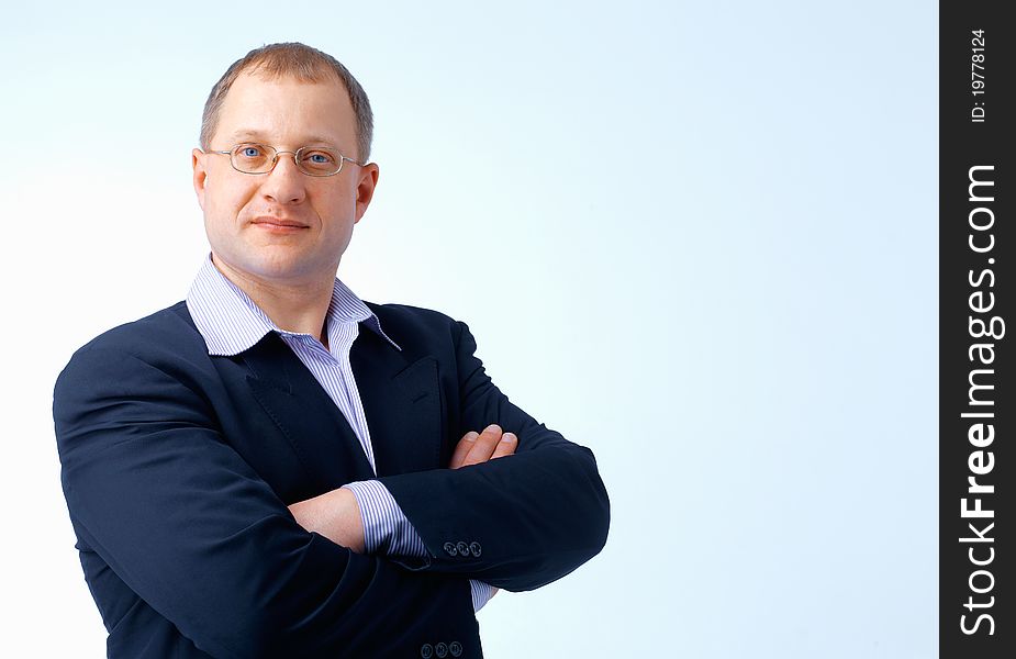 Close up portrait of a man standing with glasses,his hands folded. Close up portrait of a man standing with glasses,his hands folded.