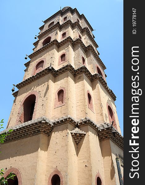 Bottom view of an ancient Chinese pagoda against blue sky. Bottom view of an ancient Chinese pagoda against blue sky