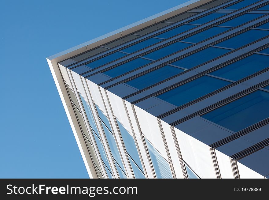 Corner of a bigger building with blue sky. Corner of a bigger building with blue sky