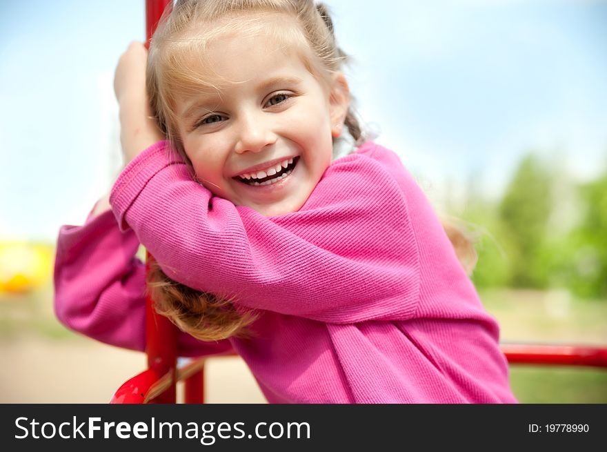 Cute little girl smiling in a park close-up