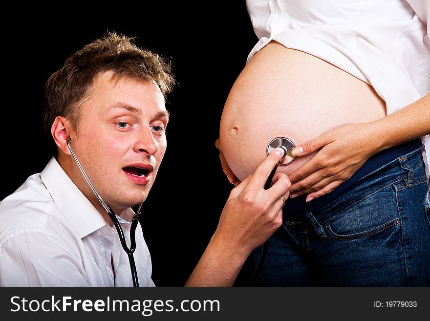 Pregnant couple on black background