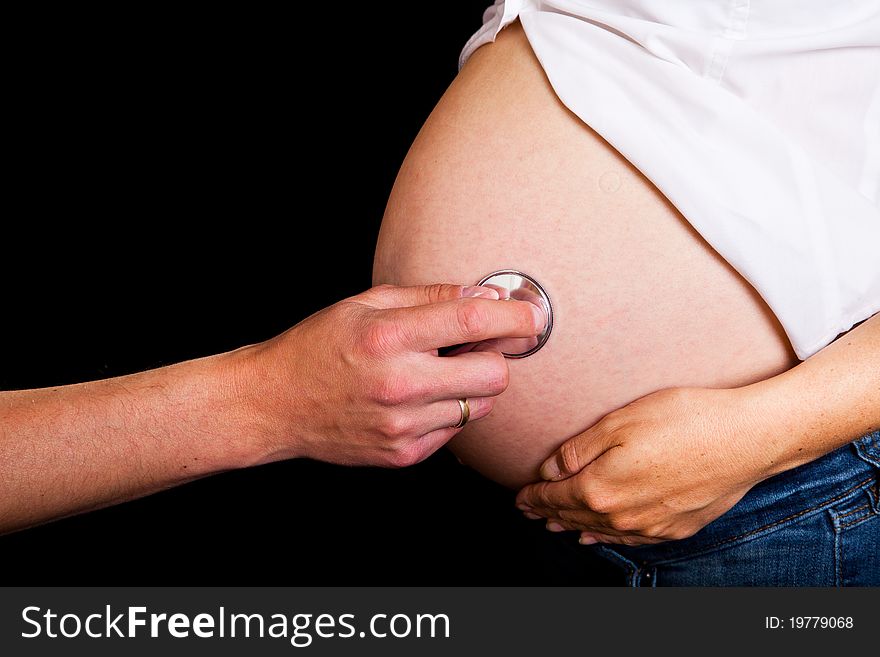 Pregnant woman on black background