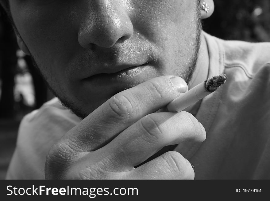 Caucasian man holding a cigar