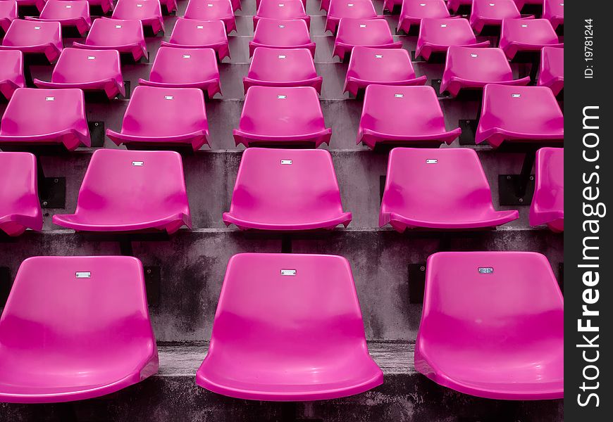 Front of the pink seats on the stadium