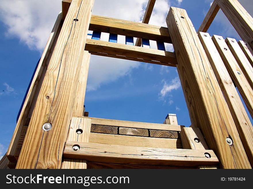 A wooden childrens play structure. A wooden childrens play structure