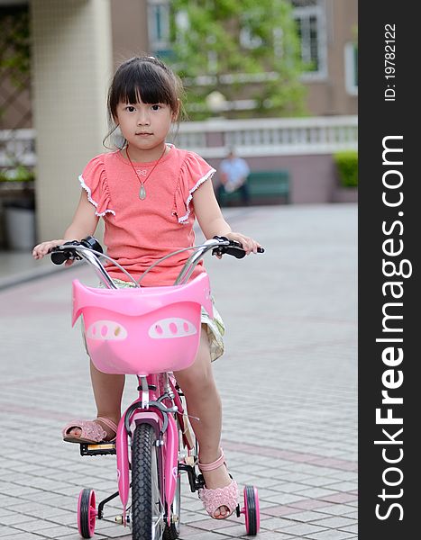 Asian Child Riding A Bicycle