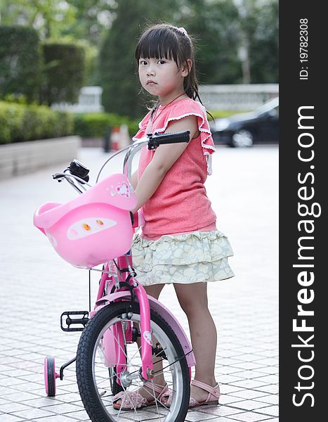 Asian Child Riding A Bicycle