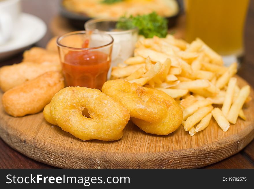 Snack - fried potatoes and squid in restaurant
