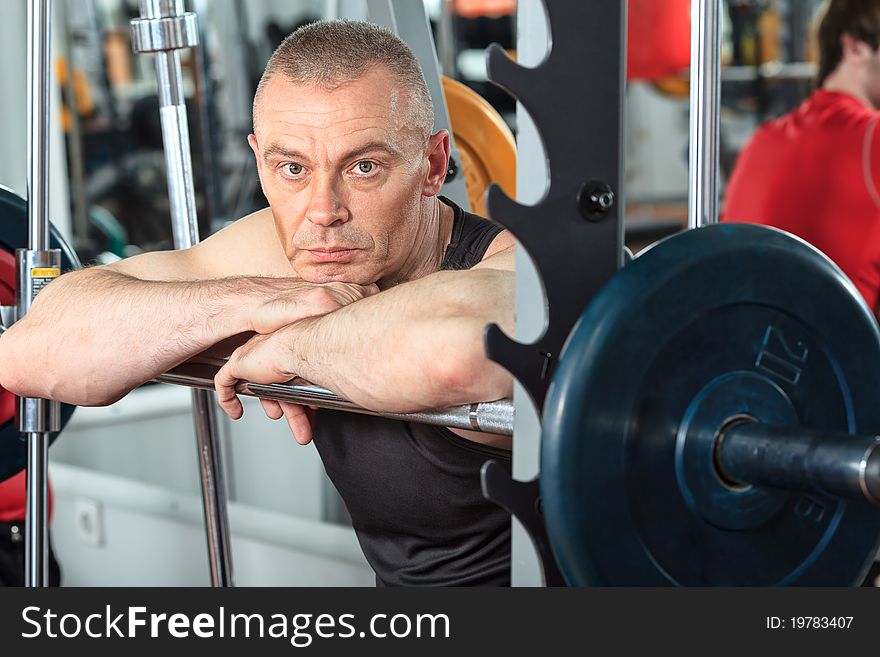 Mature sporty man in the gym centre.