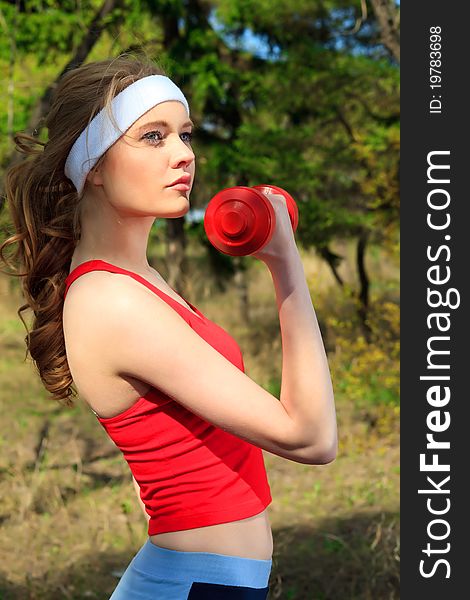 Young sporty woman is working out outdoor. Young sporty woman is working out outdoor.