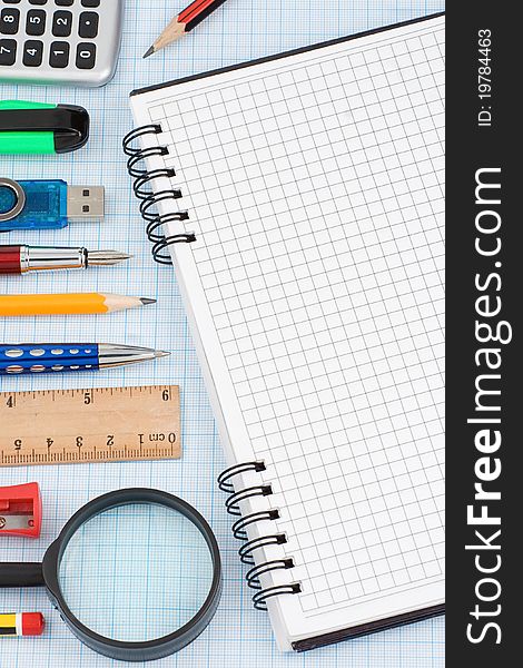 School accessories and checked notebook on graph grid paper