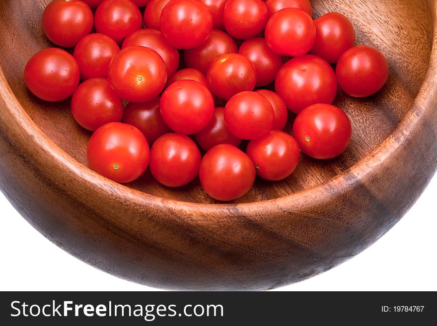 Many red cherry tomatoes in wooden bowl. Many red cherry tomatoes in wooden bowl