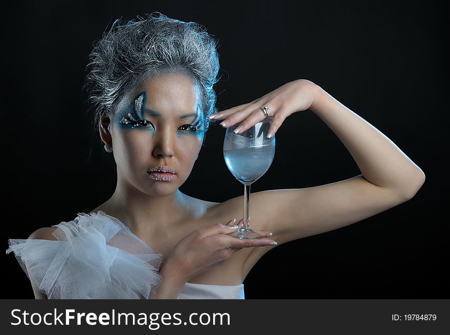 Portrait of woman with creative makeup and wineglass in her hands. Portrait of woman with creative makeup and wineglass in her hands
