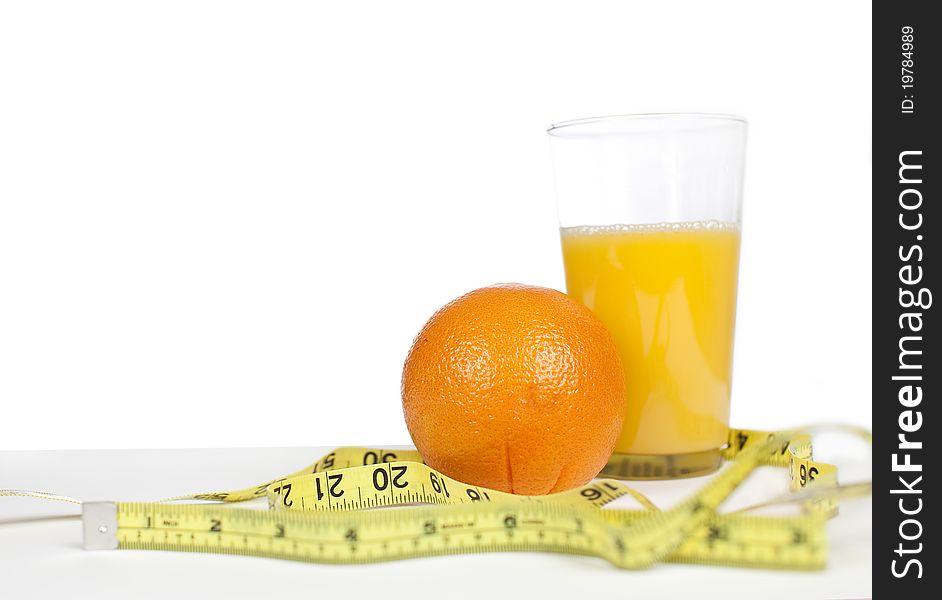 Oranges and orange juice with measuring tape
