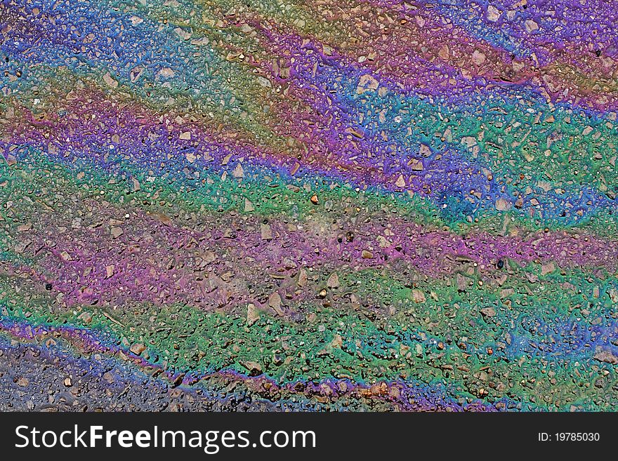 Colored oil stains on asphalt. Colored oil stains on asphalt