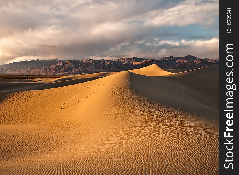 Foot prints leave a heart on the side of this sand dune. Foot prints leave a heart on the side of this sand dune.