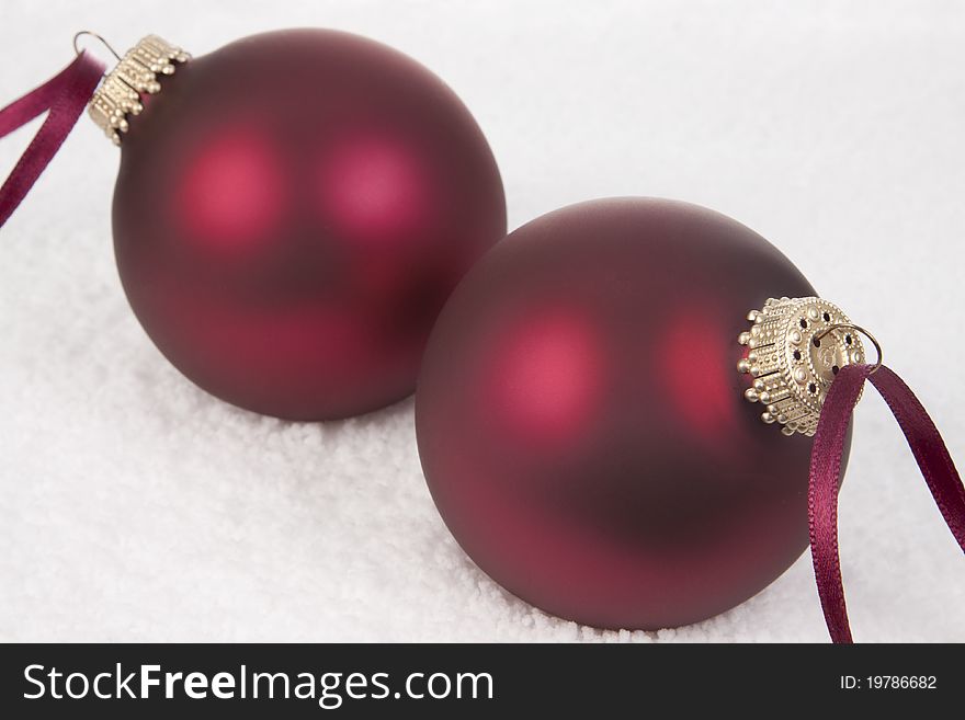 Two Christmas Ornament on a Snow background