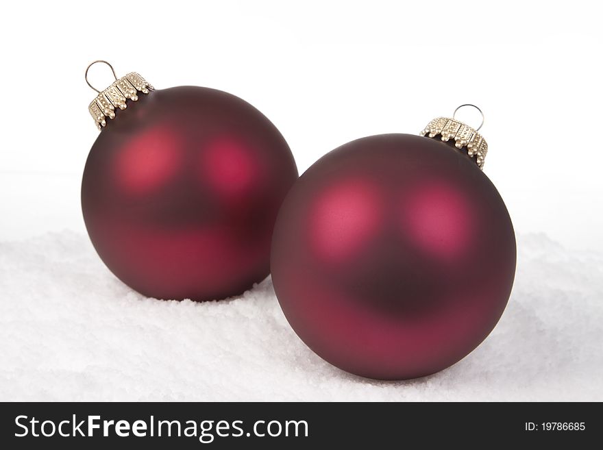 Two Red Christmas Bauble on a Snow background. Two Red Christmas Bauble on a Snow background