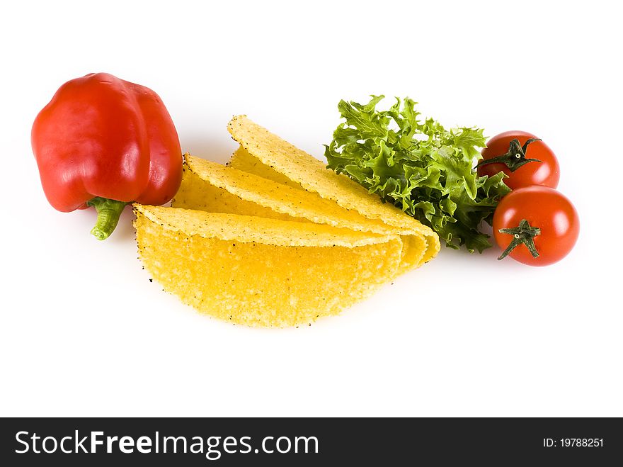 Taco shells with vegetables isolated over white background