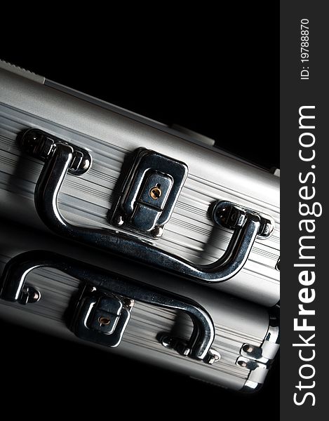 Silver suitcase isolated on a black background