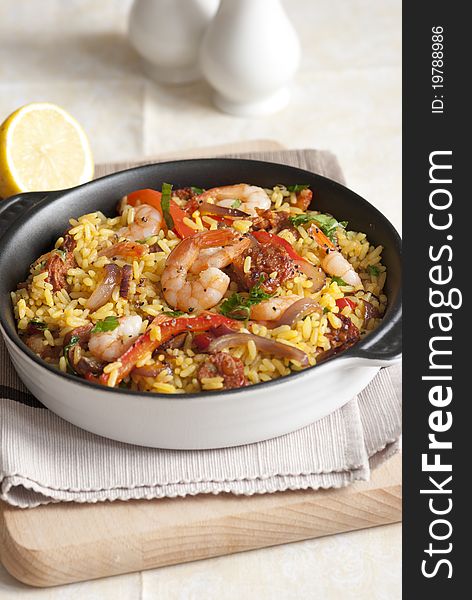Spanish rice with king prawns and chorizo in a pan. Spanish rice with king prawns and chorizo in a pan