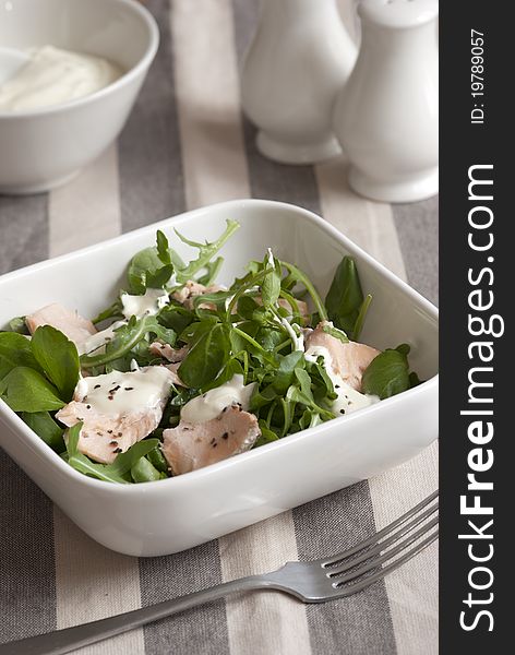 Salmon with watercress and creme fraiche in a bowl. Salmon with watercress and creme fraiche in a bowl