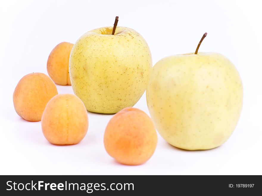 Some fresh apricot and apples isolated on white background