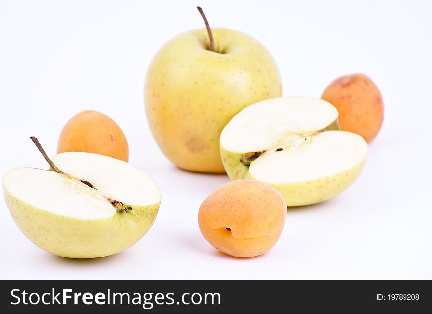 Some fresh apricot and apples isolated on white background