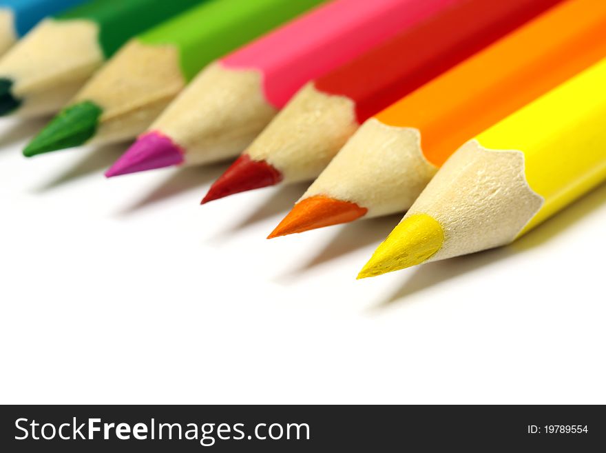 Various color pencils on white background