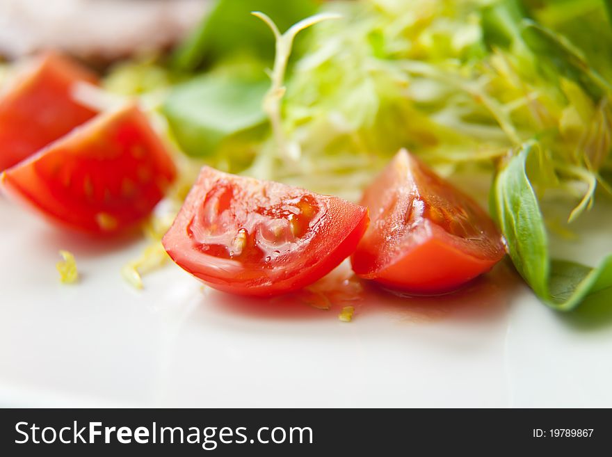 Fresh salad with tomatoes, close-up photo