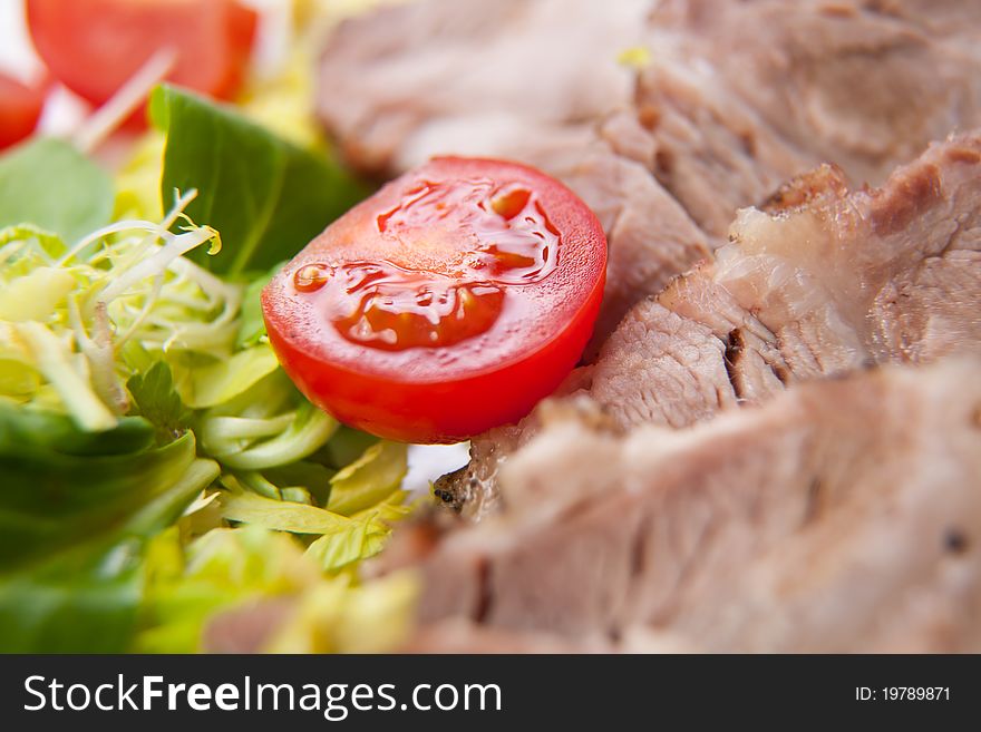 Sliced meat with fresh vegetables, close-up photo