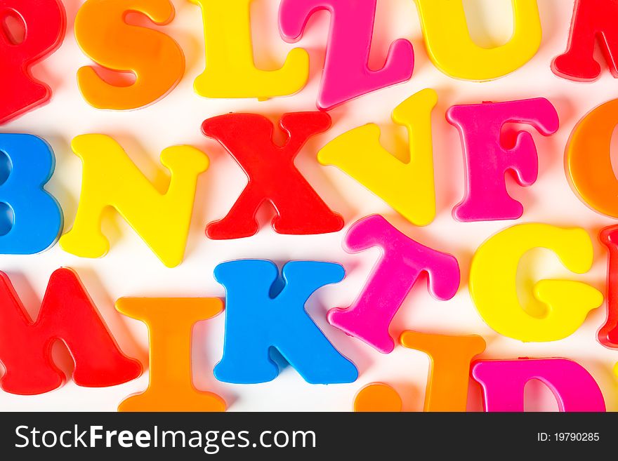 Multicolored toy letters - abstract education background. Multicolored toy letters - abstract education background