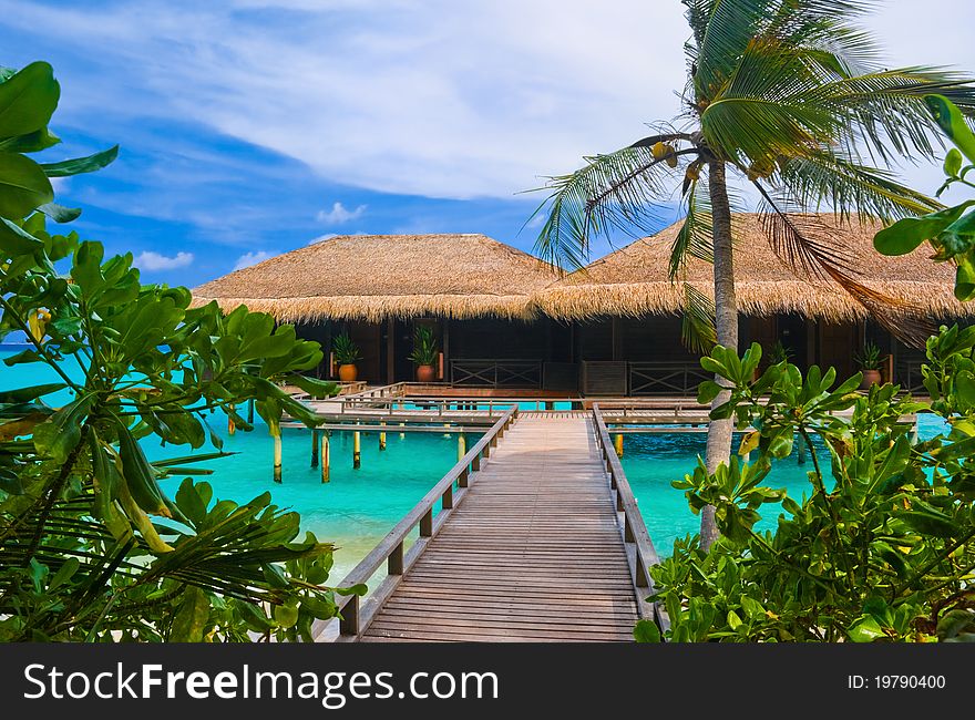 Water bungalows on a tropical island - travel background