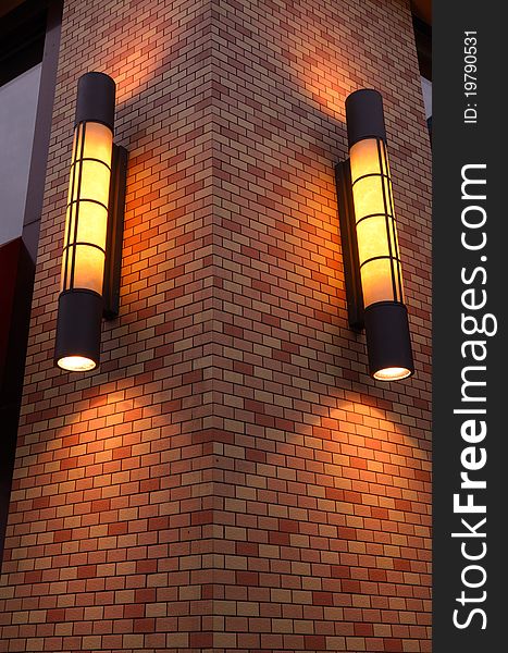 This is the exterior wall lamps of a fast-food restaurant, giving warm sense.