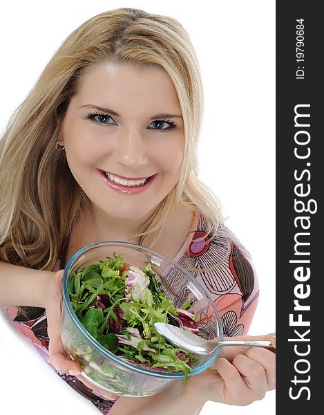 Beautiful woman eating green vegetable salad