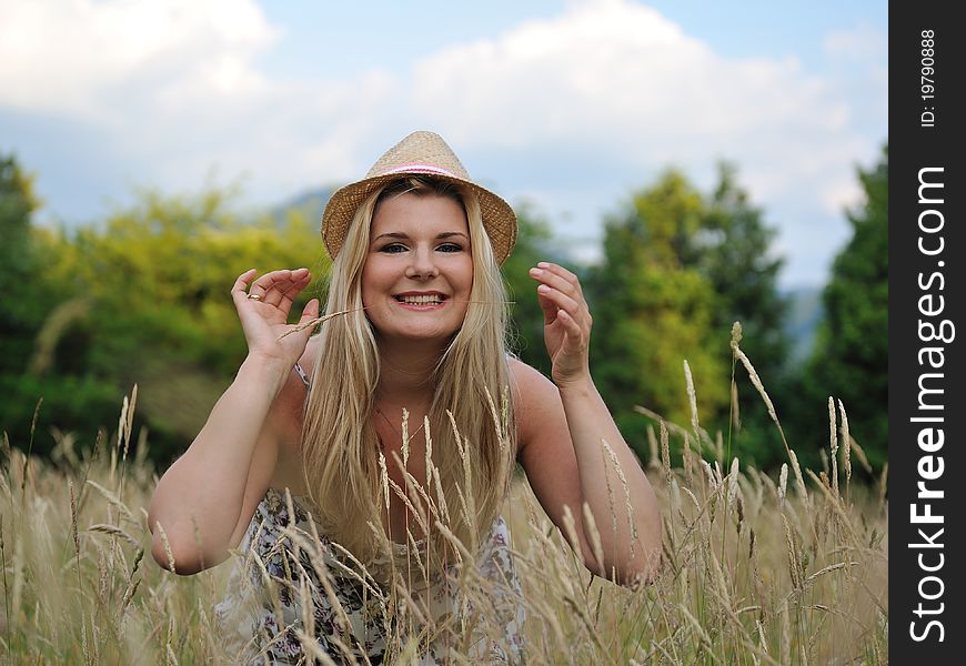 Pretty summer woman on yellow wheat field in countryside relaxing. Pretty summer woman on yellow wheat field in countryside relaxing