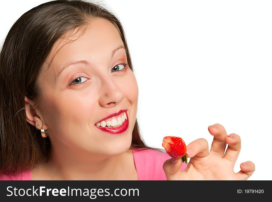 Young girl smiling shows bitten off strawberries. Young girl smiling shows bitten off strawberries