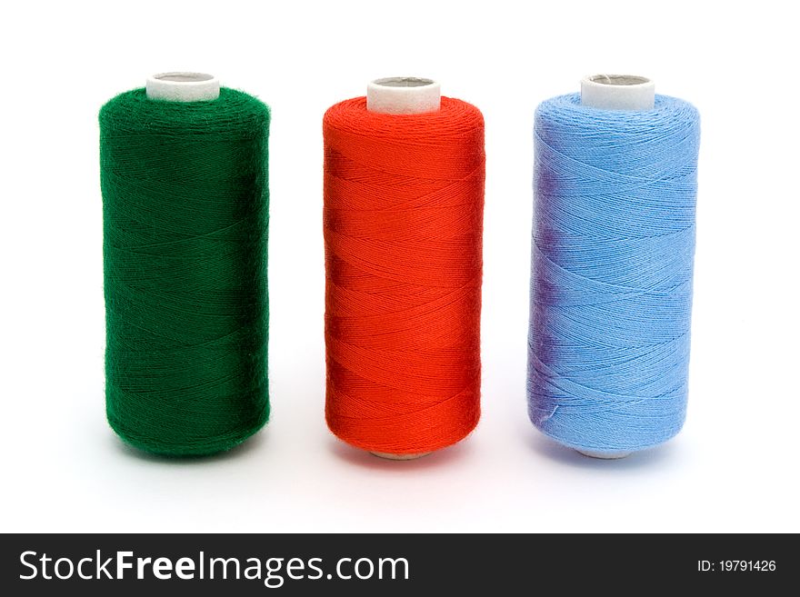 Three rolls of different colour cotton isolated on white. Three rolls of different colour cotton isolated on white