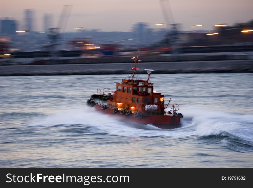 A Turkish tugboat helping a cruiseship in the Bosphorus. Selective focus.. Slow time shutter speed for the panning effect and fix the subject. A Turkish tugboat helping a cruiseship in the Bosphorus. Selective focus.. Slow time shutter speed for the panning effect and fix the subject.