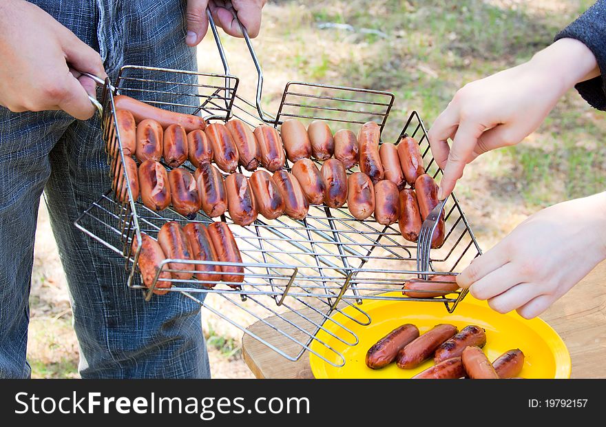 Grilled sausage or hot dog on wire rack. Grilled sausage or hot dog on wire rack